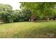 A sprawling backyard with lush greenery and mature trees offers a serene and private outdoor space at 1537 Spangler Dr, Shelby, NC 28150