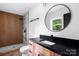 This bathroom features a modern shower, a spacious vanity with a black countertop, and stylish finishes at 1537 Spangler Dr, Shelby, NC 28150