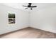 This bedroom boasts a contemporary ceiling fan, large window, and sleek floors, creating a modern, inviting space at 1537 Spangler Dr, Shelby, NC 28150