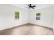 Bright, spacious bedroom with hardwood floors, two windows providing natural light, and neutral decor at 1537 Spangler Dr, Shelby, NC 28150