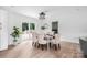Bright dining room with modern light fixture, dining table, six chairs, and sliding glass doors to the backyard deck at 1537 Spangler Dr, Shelby, NC 28150