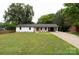 Charming single-story home featuring a vibrant red front door, a well-manicured lawn, and a convenient attached carport at 1537 Spangler Dr, Shelby, NC 28150