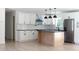 Bright kitchen features white cabinets, stainless steel appliances, black hardware, and a kitchen island at 1537 Spangler Dr, Shelby, NC 28150