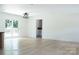 Spacious living room with new flooring, large windows, sliding glass door, and modern lighting at 1537 Spangler Dr, Shelby, NC 28150