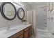 Bathroom featuring a double sink vanity, shower-tub, and decorative wall art at 16930 Summers Walk Blvd, Davidson, NC 28036