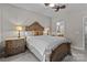 Luxurious bedroom with ornate wood trim, ceiling fan, and well-lit bedside tables at 16930 Summers Walk Blvd, Davidson, NC 28036