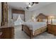 Bright bedroom featuring large windows, ornate wood furniture, and a ceiling fan at 16930 Summers Walk Blvd, Davidson, NC 28036