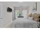 Inviting bedroom featuring an Eiffel Tower poster, plush pillows, and bright windows at 16930 Summers Walk Blvd, Davidson, NC 28036