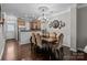 Elegant dining room with chandelier, decorative mirror art, and seamless access to kitchen at 16930 Summers Walk Blvd, Davidson, NC 28036