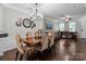 Charming dining room with hardwood floors, chandelier lighting, and an open layout to living room at 16930 Summers Walk Blvd, Davidson, NC 28036