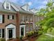 Charming brick townhome featuring manicured landscaping, dormer windows and covered front entry at 16930 Summers Walk Blvd, Davidson, NC 28036