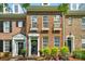 Charming brick townhome featuring a classic design, black shutters, and beautiful landscaping at 16930 Summers Walk Blvd, Davidson, NC 28036
