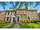 Charming brick townhome featuring black shutters, a welcoming entrance, and beautiful landscaping at 16930 Summers Walk Blvd, Davidson, NC 28036