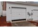 Attached two-car garage with white siding and ample parking space with modern door design at 16930 Summers Walk Blvd, Davidson, NC 28036