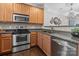 Modern kitchen with stainless steel oven, microwave, and tiled backsplash at 16930 Summers Walk Blvd, Davidson, NC 28036