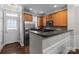 Well-lit kitchen featuring stainless steel appliances and adjacent entry door at 16930 Summers Walk Blvd, Davidson, NC 28036