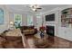 Cozy living room featuring a fireplace, hardwood floors, and large windows for natural light at 16930 Summers Walk Blvd, Davidson, NC 28036