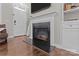 Living room featuring fireplace, built-in shelving, wood flooring, and an abundance of natural light at 16930 Summers Walk Blvd, Davidson, NC 28036