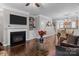 Inviting living room featuring a cozy fireplace, built-in shelves, hardwood floors, and elegant decor at 16930 Summers Walk Blvd, Davidson, NC 28036