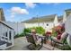 Outdoor patio area with comfortable seating, lush landscaping, and a privacy fence at 16930 Summers Walk Blvd, Davidson, NC 28036