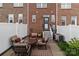 Brick patio with outdoor seating, overlooking a fenced backyard and a brick building at 16930 Summers Walk Blvd, Davidson, NC 28036