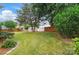 Spacious backyard featuring lush green grass, mature trees, and a convenient storage shed at 170 Heywatchis Dr, Mooresville, NC 28115