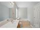 Bright bathroom features a soaking tub, a toilet, a single sink vanity and window at 170 Heywatchis Dr, Mooresville, NC 28115