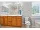 Bright bathroom features a double sink vanity, a toilet, and a shower with glass door at 170 Heywatchis Dr, Mooresville, NC 28115