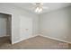 This bedroom features neutral walls and carpet, ceiling fan, and double door closet at 170 Heywatchis Dr, Mooresville, NC 28115