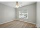 This bedroom features neutral walls and carpet, ceiling fan, and a large window for natural light at 170 Heywatchis Dr, Mooresville, NC 28115