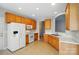 Bright kitchen featuring oak cabinets, white appliances, and tile flooring at 170 Heywatchis Dr, Mooresville, NC 28115