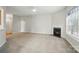 Spacious living room with a fireplace, ceiling fan, and bright windows at 170 Heywatchis Dr, Mooresville, NC 28115