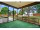 Relax on this screened porch offering a serene view of the private backyard and storage shed at 170 Heywatchis Dr, Mooresville, NC 28115