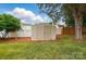 Backyard featuring a well-maintained storage shed on a lush green lawn with mature trees at 170 Heywatchis Dr, Mooresville, NC 28115