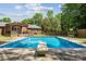 Beautiful backyard features a sparkling pool and brick home with a wood pergola at 1753 Elmwood Dr, Rock Hill, SC 29730