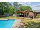 Backyard with in-ground pool, wooden deck, pergola and privacy fencing at 1753 Elmwood Dr, Rock Hill, SC 29730