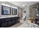 Bathroom featuring double vanity, walk-in shower with glass doors and tile surround, wood-look floors, and gray walls at 1753 Elmwood Dr, Rock Hill, SC 29730