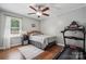 Bedroom with hardwood floors, neutral paint, ceiling fan, window, and a treadmill for exercising in your own space at 1753 Elmwood Dr, Rock Hill, SC 29730