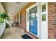 Inviting front porch with a blue door, classic brickwork and comfortable seating, creating a cozy entrance at 1753 Elmwood Dr, Rock Hill, SC 29730