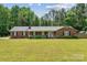 Charming brick home featuring a well-manicured lawn and a welcoming front porch, perfect for enjoying the outdoors at 1753 Elmwood Dr, Rock Hill, SC 29730