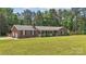 Traditional brick home with an attached garage, a covered front porch and lush green lawn at 1753 Elmwood Dr, Rock Hill, SC 29730