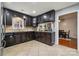 Kitchen featuring dark cabinets, granite countertops, breakfast bar, and view to dining area at 1753 Elmwood Dr, Rock Hill, SC 29730