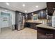 Kitchen with dark cabinetry, stainless steel appliances, a double sink, and tile backsplash at 1753 Elmwood Dr, Rock Hill, SC 29730