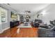 Comfortable living room with a brick fireplace, hardwood floors, and large windows, creating a cozy atmosphere at 1753 Elmwood Dr, Rock Hill, SC 29730