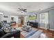 Comfortable living room showcasing hardwood floors, a ceiling fan, and large windows, perfect for relaxing at 1753 Elmwood Dr, Rock Hill, SC 29730