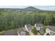 Aerial view of several homes with mature trees and a distant mountain at 1835 Allegheny Dr, Gastonia, NC 28054