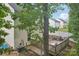 Backyard featuring a wooden deck, partial fence, and mature trees at 1835 Allegheny Dr, Gastonia, NC 28054