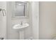 Stylish half-bath features a pedestal sink and framed mirror, offering a clean aesthetic at 1835 Allegheny Dr, Gastonia, NC 28054