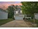 Charming two-story home with a white garage door, black shutters, and a well-manicured lawn at 1835 Allegheny Dr, Gastonia, NC 28054
