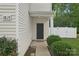 Inviting home entrance featuring a black front door, manicured bushes, and white siding at 1835 Allegheny Dr, Gastonia, NC 28054